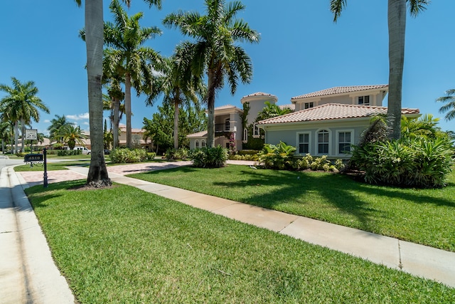 mediterranean / spanish house featuring a front lawn