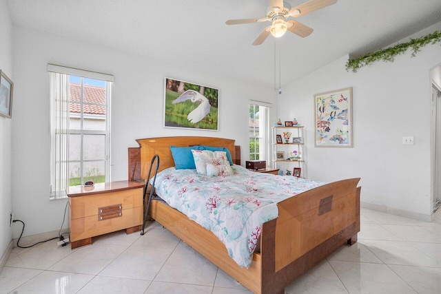 bedroom featuring light tile patterned floors, ceiling fan, and lofted ceiling