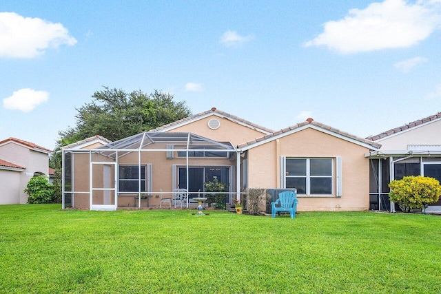 rear view of property featuring a yard and a lanai