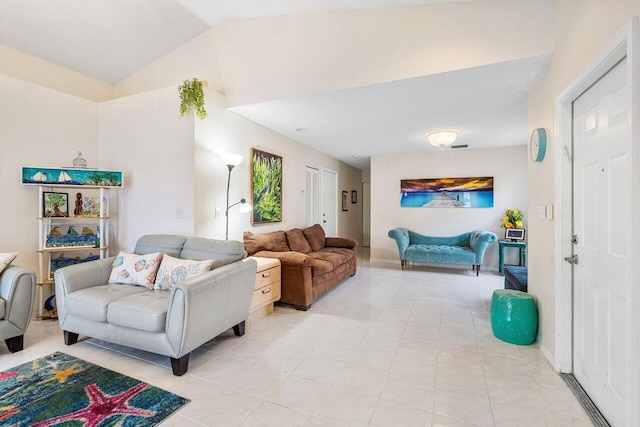 living room with light tile patterned floors and lofted ceiling