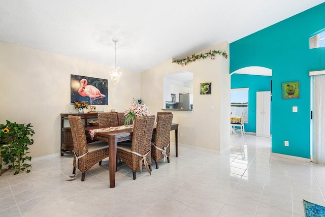 tiled dining area featuring a notable chandelier