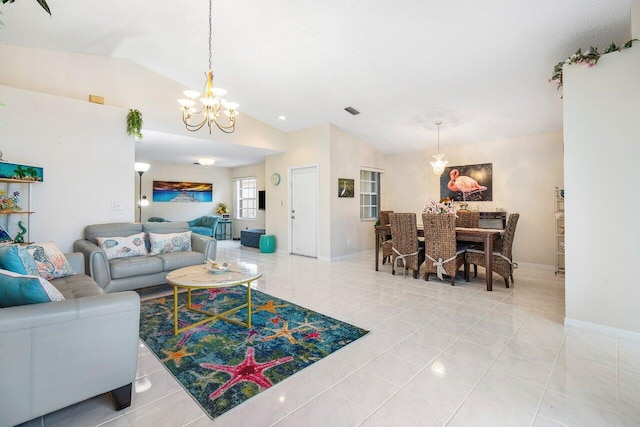 tiled living room featuring lofted ceiling and a chandelier