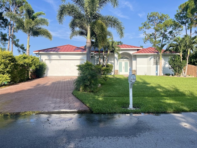 view of front facade featuring a garage and a front lawn