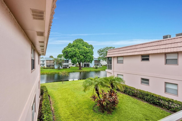 view of yard with a water view and visible vents