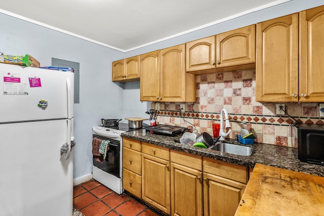 kitchen featuring backsplash, white appliances, dark tile patterned floors, and sink