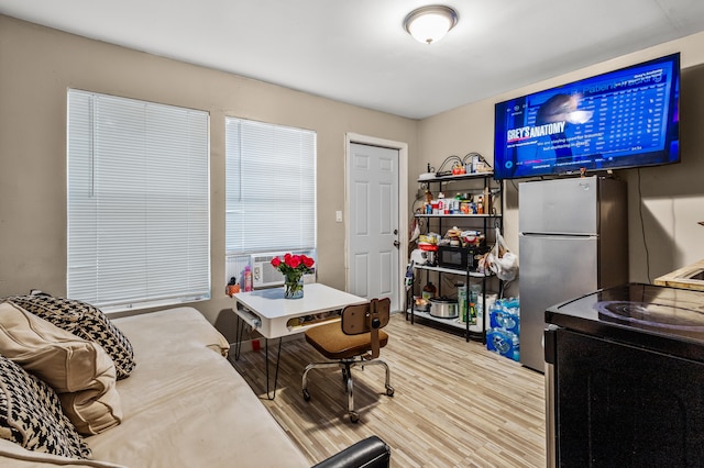 interior space with stainless steel fridge, cooling unit, and light hardwood / wood-style floors