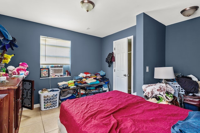 bedroom featuring cooling unit and light tile patterned floors