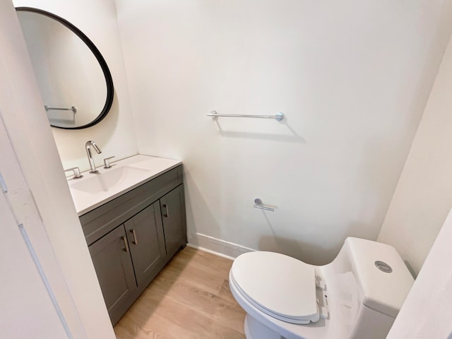 bathroom featuring hardwood / wood-style floors, toilet, and vanity