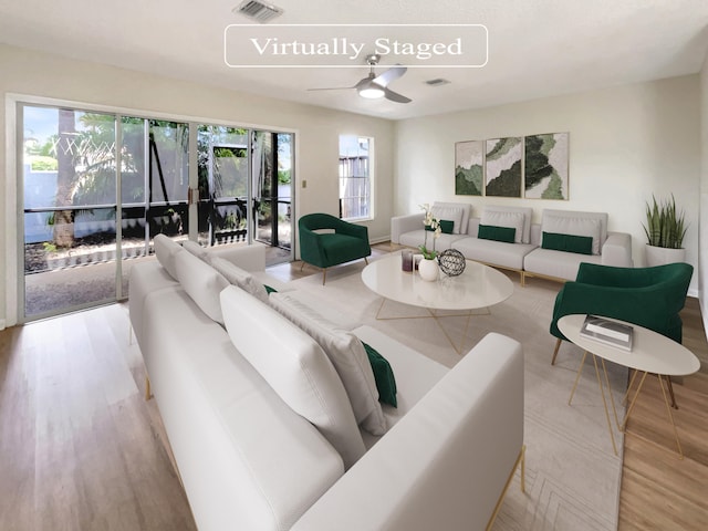 living room with ceiling fan and light wood-type flooring