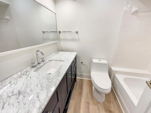 bathroom featuring hardwood / wood-style flooring, vanity, and toilet