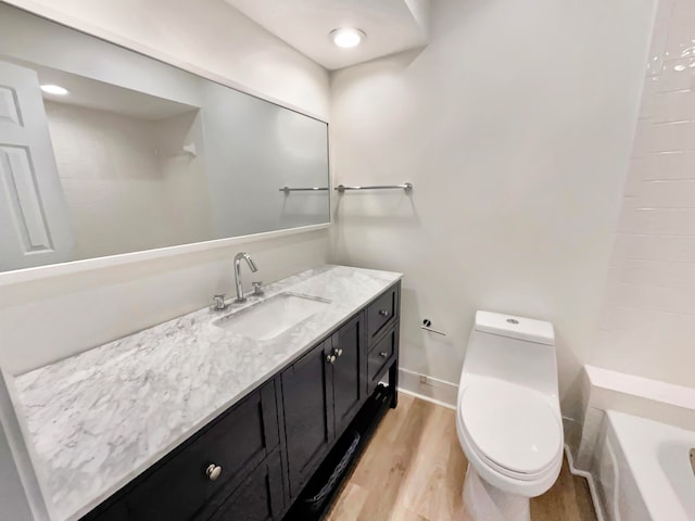 bathroom featuring hardwood / wood-style flooring, vanity, and toilet