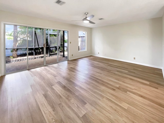 unfurnished room with ceiling fan and light wood-type flooring