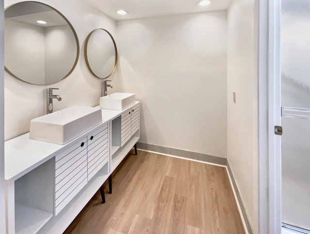 bathroom with hardwood / wood-style flooring and vanity