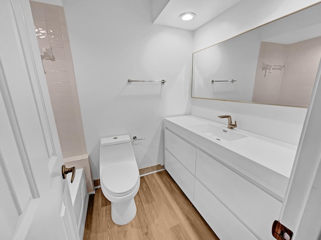 bathroom featuring hardwood / wood-style floors, vanity, and toilet