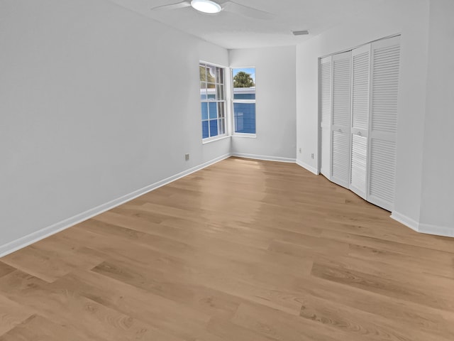 unfurnished bedroom featuring light wood-type flooring, a closet, and ceiling fan