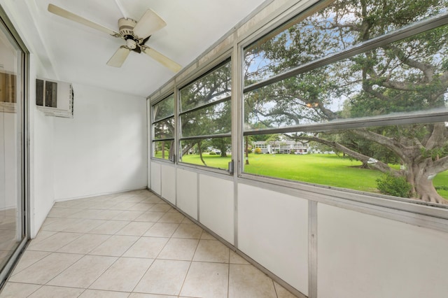 unfurnished sunroom with ceiling fan and an AC wall unit