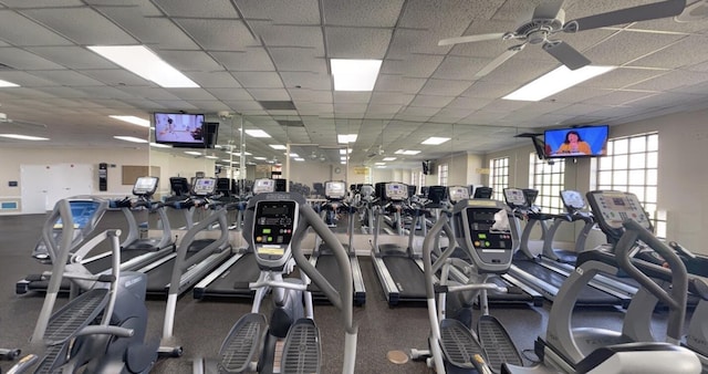 gym with a paneled ceiling and ceiling fan