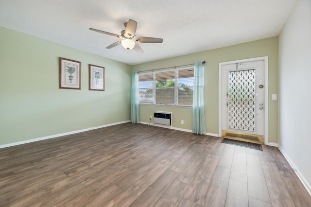 unfurnished living room featuring ceiling fan, wood-type flooring, and a textured ceiling