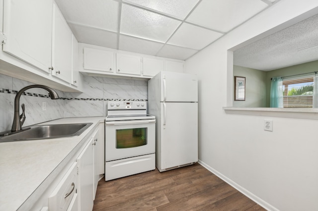 kitchen with sink, dark wood-type flooring, decorative backsplash, white appliances, and white cabinets