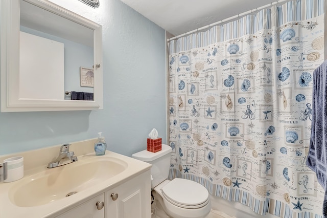 bathroom featuring toilet and vanity