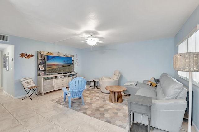 tiled living room with ceiling fan