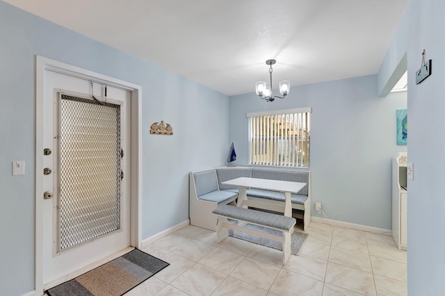 dining space with a chandelier and light tile patterned floors