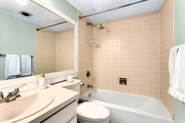 full bathroom with toilet, tiled shower / bath combo, and vanity