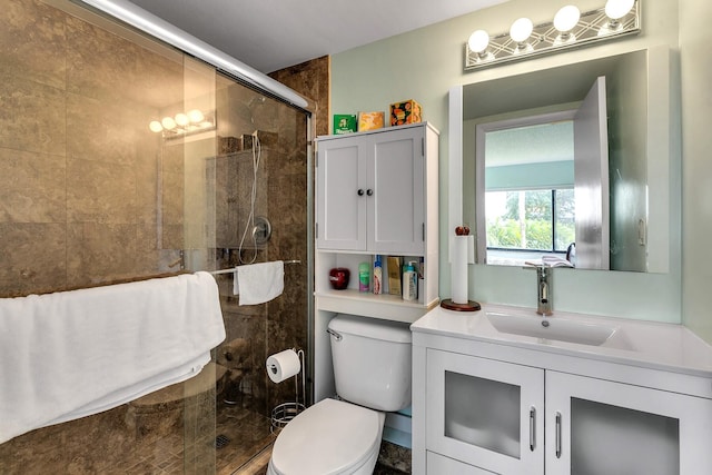 bathroom with toilet, walk in shower, and vanity