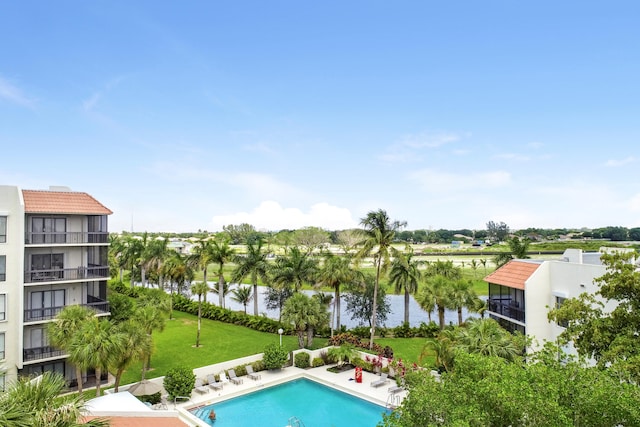 view of pool with a lawn