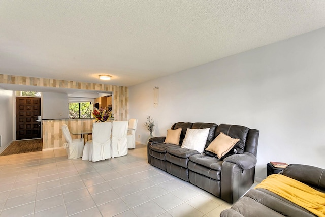 living room with light tile patterned floors and a textured ceiling