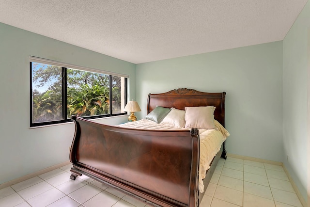 tiled bedroom featuring a textured ceiling