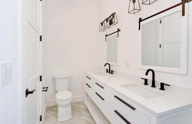 bathroom with dual vanity, toilet, and tile patterned floors