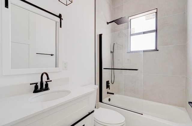 full bathroom with toilet, tiled shower / bath, and vanity