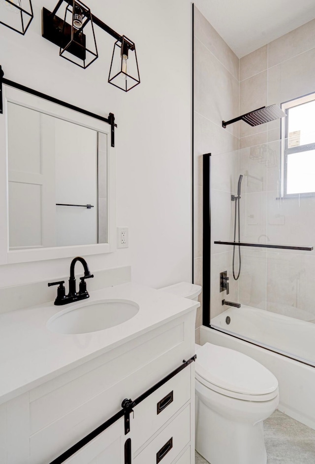 full bathroom with toilet, tiled shower / bath combo, and vanity