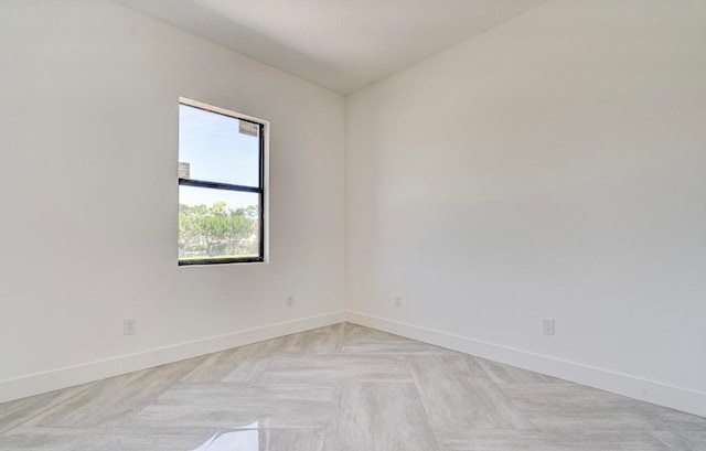 unfurnished room featuring light parquet flooring