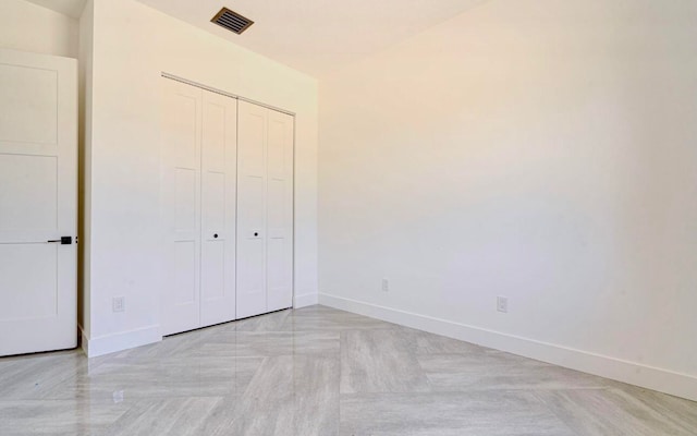 unfurnished bedroom with a closet