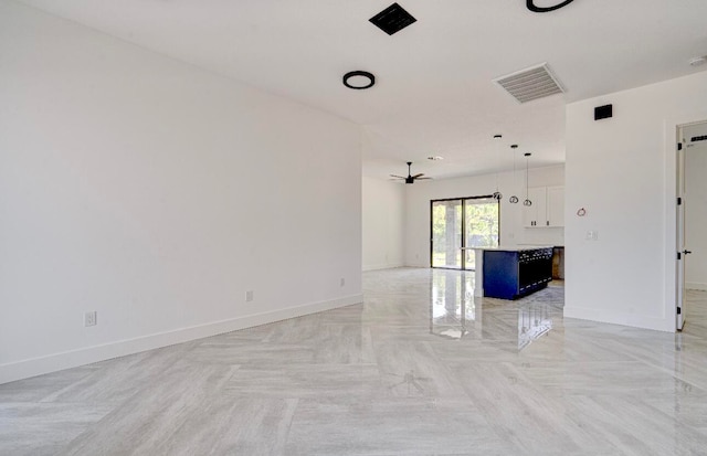 unfurnished living room with ceiling fan and light parquet flooring