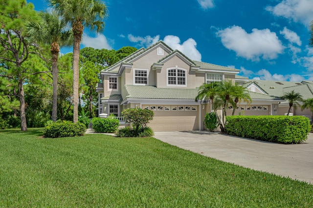 front facade with a garage and a front yard