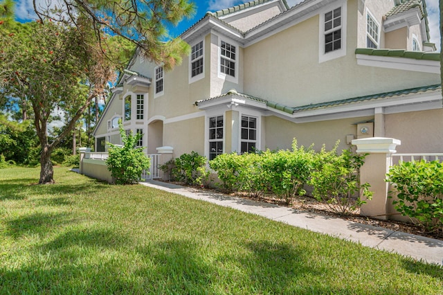 view of home's exterior with a yard