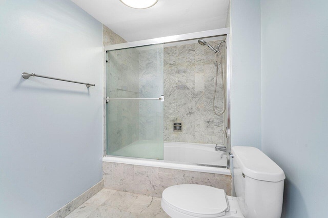 bathroom with tile patterned floors, toilet, and shower / bath combination with glass door