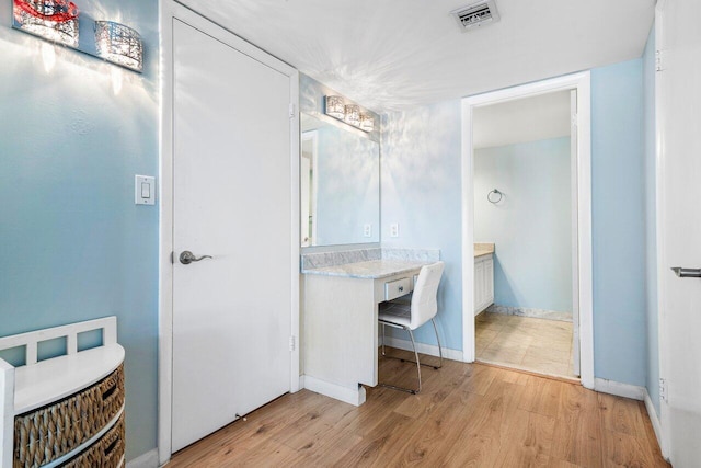 bathroom with vanity and wood-type flooring