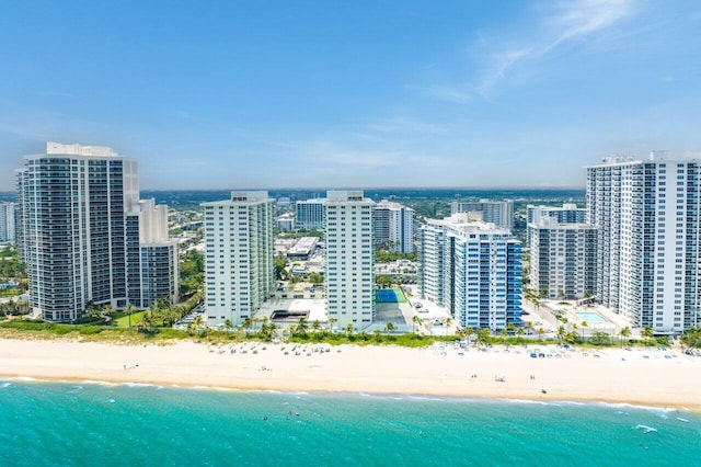 drone / aerial view featuring a view of the beach and a water view