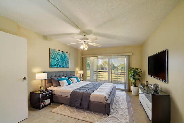 bedroom with ceiling fan, light tile patterned floors, a textured ceiling, and access to outside