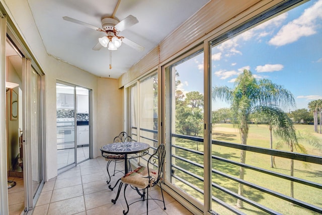 sunroom / solarium featuring ceiling fan