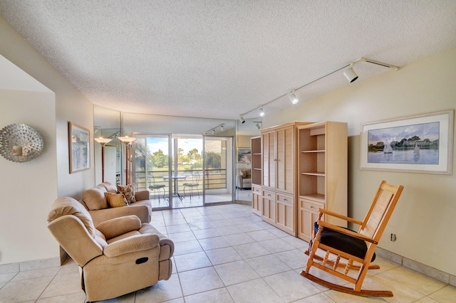 living room featuring a textured ceiling and light tile patterned floors