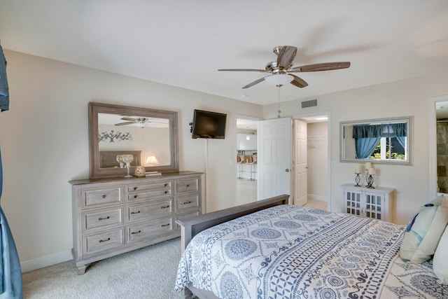 carpeted bedroom with ceiling fan, a spacious closet, and a closet