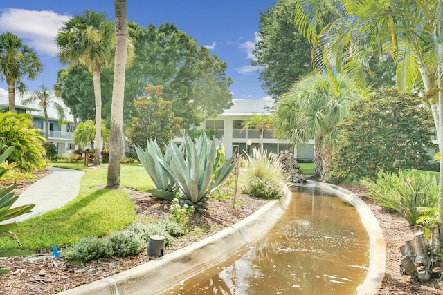 view of property's community with a yard