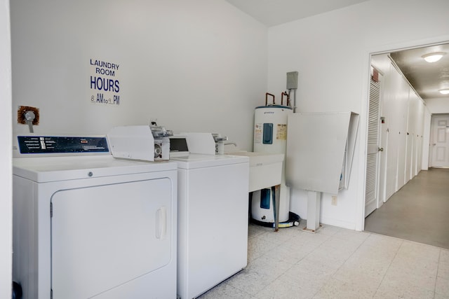 clothes washing area featuring light tile patterned flooring and washing machine and dryer