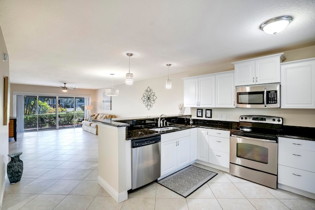 kitchen with white cabinetry, kitchen peninsula, appliances with stainless steel finishes, and light tile patterned floors