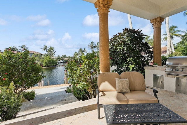 view of patio with a water view, an outdoor living space, area for grilling, and a grill